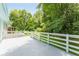 Large back deck with white railings overlooking a well maintained lawn and wooded area at 2343 Dawn Dr, Decatur, GA 30032
