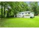 Spacious backyard featuring a well-maintained lawn, complemented by a charming two-story house at 2343 Dawn Dr, Decatur, GA 30032