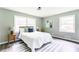 Bright bedroom featuring a queen bed, light gray walls, wood floors, and natural light from two windows at 2343 Dawn Dr, Decatur, GA 30032
