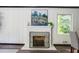Fireplace in the dining area features brick accents and adjacent window at 2343 Dawn Dr, Decatur, GA 30032