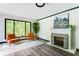 Inviting living room with hardwood floors, fireplace, and a large window with views of a lush green yard at 2343 Dawn Dr, Decatur, GA 30032
