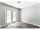 Empty room features new gray walls and wood-look floors, with glass doors leading to outdoor area at 2343 Dawn Dr, Decatur, GA 30032