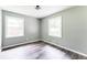 Empty gray room showcases wood floors and natural light from two windows at 2343 Dawn Dr, Decatur, GA 30032