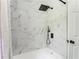 Modern tiled shower with black hardware and a black shower head at 2343 Dawn Dr, Decatur, GA 30032