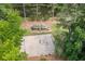Aerial view showcasing a community park featuring a playground, basketball court, and lush green surroundings at 2717 Hearthstone Cir, Marietta, GA 30062