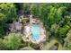 Aerial view of the community pool area featuring a pool, clubhouse, and walking path at 2717 Hearthstone Cir, Marietta, GA 30062