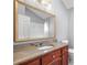 Bathroom vanity with marble countertop, wood cabinets, and a large mirror at 2717 Hearthstone Cir, Marietta, GA 30062