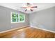 This spacious bedroom features gleaming hardwood floors and a bright window at 2717 Hearthstone Cir, Marietta, GA 30062