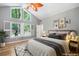 Staged bedroom features large windows, overhead fan and curated wall art at 2717 Hearthstone Cir, Marietta, GA 30062