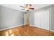 Bedroom with hardwood floors, ceiling fan, and closet space for ample storage at 2717 Hearthstone Cir, Marietta, GA 30062