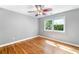 Bright bedroom featuring hardwood floors, ceiling fan, and a large window with natural light at 2717 Hearthstone Cir, Marietta, GA 30062