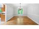 Empty dining room with hardwood floors, chandelier, large window, and adjacent kitchen at 2717 Hearthstone Cir, Marietta, GA 30062