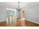 Open dining room featuring hardwood floors, decorative chandelier, and white trim at 2717 Hearthstone Cir, Marietta, GA 30062