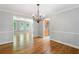 Open dining room featuring a chandelier and an adjacent living room with hardwood flooring at 2717 Hearthstone Cir, Marietta, GA 30062
