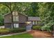 Charming home featuring stone accents, neutral siding, and well-manicured landscaping with mature trees at 2717 Hearthstone Cir, Marietta, GA 30062