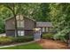Charming home featuring stone accents, a well-manicured lawn, and a walkway leading to the front door at 2717 Hearthstone Cir, Marietta, GA 30062