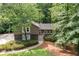 Charming home featuring stone accents, a well-manicured lawn, and a walkway leading to the front door at 2717 Hearthstone Cir, Marietta, GA 30062