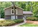 Charming home featuring stone accents and gray trim, surrounded by lush landscaping and mature trees at 2717 Hearthstone Cir, Marietta, GA 30062