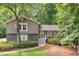 Charming home featuring stone accents and gray trim, surrounded by lush landscaping and mature trees at 2717 Hearthstone Cir, Marietta, GA 30062