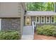Charming home featuring stone accents and gray trim, surrounded by lush landscaping and mature trees at 2717 Hearthstone Cir, Marietta, GA 30062