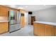 Spacious kitchen with stainless steel refrigerator, ample cabinet storage, and adjacent staircase at 2717 Hearthstone Cir, Marietta, GA 30062