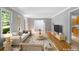 Staged living room features a plush sofa, modern furniture, hardwood floors and lots of natural light at 2717 Hearthstone Cir, Marietta, GA 30062