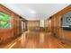 Spacious living room features hardwood floors, wood paneled walls and doors to a deck at 2717 Hearthstone Cir, Marietta, GA 30062