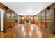 A living room boasting hardwood floors, a stone fireplace, wood paneling, and unique oval windows at 2717 Hearthstone Cir, Marietta, GA 30062