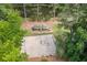Aerial view of playground with basketball court, slides, and swings near a pond at 2717 Hearthstone Cir, Marietta, GA 30062