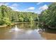 Scenic view of a serene pond with a fountain and lush greenery surrounding the area at 2717 Hearthstone Cir, Marietta, GA 30062