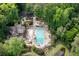 Aerial view of a community pool and clubhouse surrounded by lush trees and landscaping at 2717 Hearthstone Cir, Marietta, GA 30062