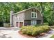 Charming home featuring a rear-entry garage and stone accents, surrounded by lush landscaping and mature trees at 2717 Hearthstone Cir, Marietta, GA 30062
