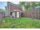 Small backyard with wooden fence and storage building at 7155 Roswell Rd # 58, Atlanta, GA 30328