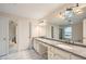 Bright bathroom featuring dual sinks with granite counters and large mirrors at 7155 Roswell Rd # 58, Atlanta, GA 30328