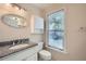 Bathroom with granite countertop and white cabinets and a window at 7155 Roswell Rd # 58, Atlanta, GA 30328