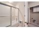 Bright bathroom featuring a glass-enclosed shower and a door to laundry room at 7155 Roswell Rd # 58, Atlanta, GA 30328