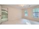 Well-lit bedroom offering two windows, a ceiling fan, neutral carpet and ample closet space at 7155 Roswell Rd # 58, Atlanta, GA 30328