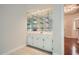 Charming butler pantry featuring stylish mirrored backsplash, white cabinets, and marble countertops at 7155 Roswell Rd # 58, Atlanta, GA 30328