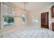 Dining area features bright white tile floors, and natural light from large window at 7155 Roswell Rd # 58, Atlanta, GA 30328