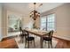 Dining room with hardwood floors, stylish chandelier, and seamless access to the living room at 7155 Roswell Rd # 58, Atlanta, GA 30328