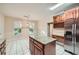 Eat-in kitchen featuring an island, stainless steel refrigerator and granite counters at 7155 Roswell Rd # 58, Atlanta, GA 30328