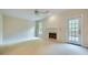 Comfortable living room featuring a fireplace and a door leading to the backyard at 7155 Roswell Rd # 58, Atlanta, GA 30328