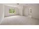 Bright bedroom with neutral carpet, trim, and walls plus a large window at 1595 Bakers Glen Dr, Atlanta, GA 30350