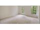 Neutral bedroom with carpet floors and a view of the trees through the window at 1595 Bakers Glen Dr, Atlanta, GA 30350