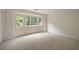Sunny bedroom featuring bay windows, carpet floors, and neutral walls at 1595 Bakers Glen Dr, Atlanta, GA 30350