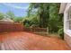 Exterior wooden deck overlooks a lush backyard with mature trees at 1595 Bakers Glen Dr, Atlanta, GA 30350