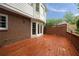 Spacious wooden deck with access to the house through glass doors and a brick facade at 1595 Bakers Glen Dr, Atlanta, GA 30350