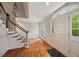 Inviting foyer with hardwood floors, staircase, and plenty of natural light from the large front door at 1595 Bakers Glen Dr, Atlanta, GA 30350