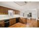 Kitchen with white counters and black dishwasher, seamlessly connecting to a dining area at 1595 Bakers Glen Dr, Atlanta, GA 30350