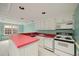 The kitchen features white appliances, a red countertop, and a window to the backyard at 1595 Bakers Glen Dr, Atlanta, GA 30350